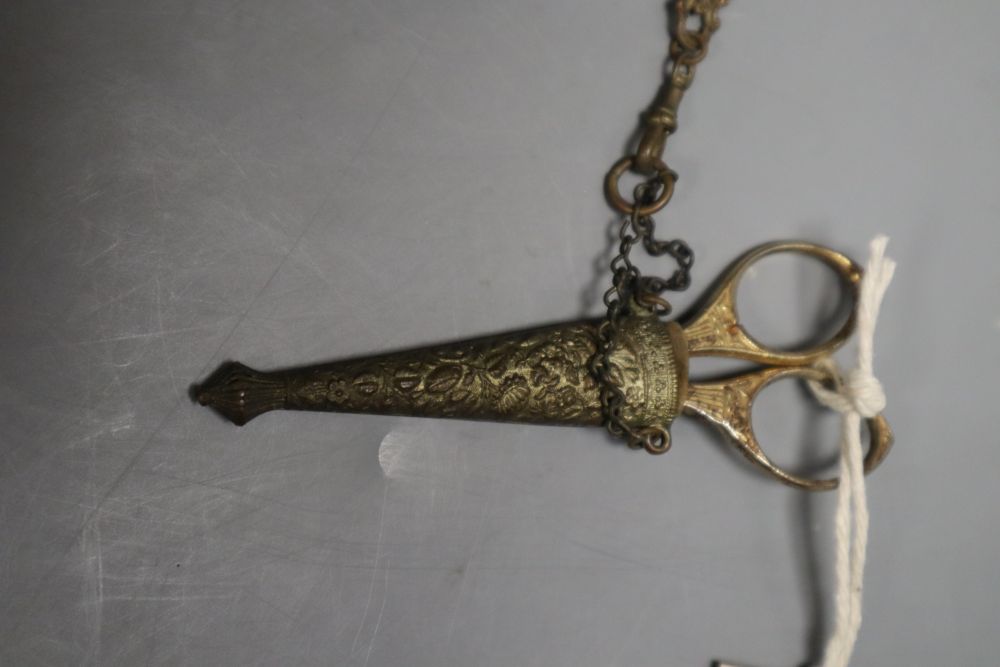 A Victorian embossed metal chatelaine, with seven attached domestic accessories, height 36cm